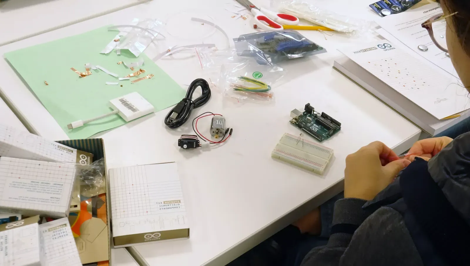 A student works on their device during the physical computing intensive